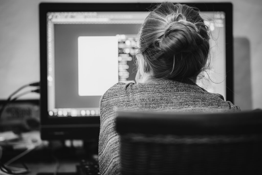 Woman in front of a desktop computer